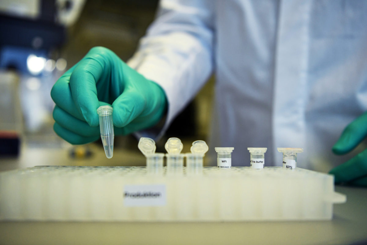 FILE PHOTO: Employee Philipp Hoffmann, of German biopharmaceutical company CureVac, demonstrates research workflow on a vaccine for the coronavirus (COVID 19) disease at a laboratory in Tuebingen